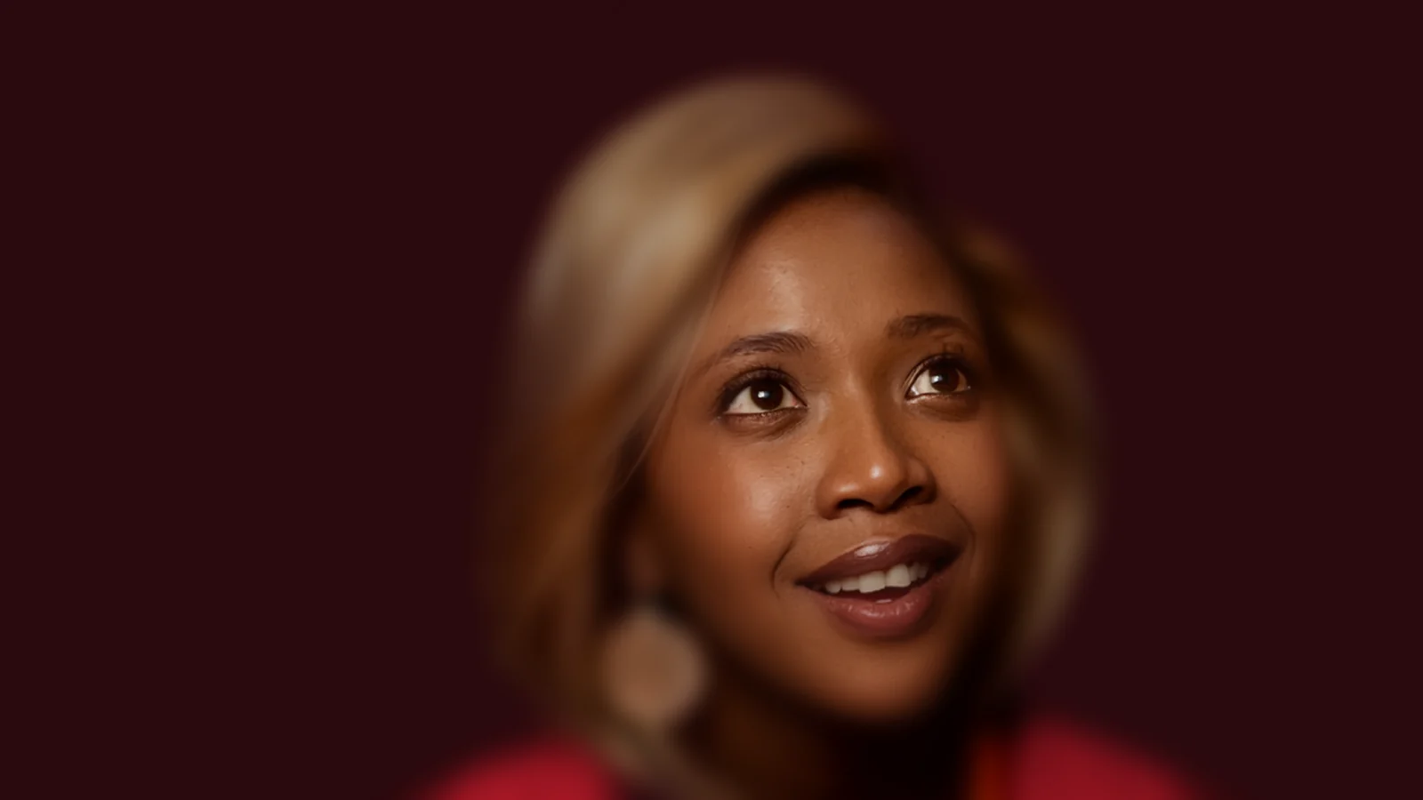 Absa ChatBanking on WhatsApp — a woman in a warm, cinematic campaign frame