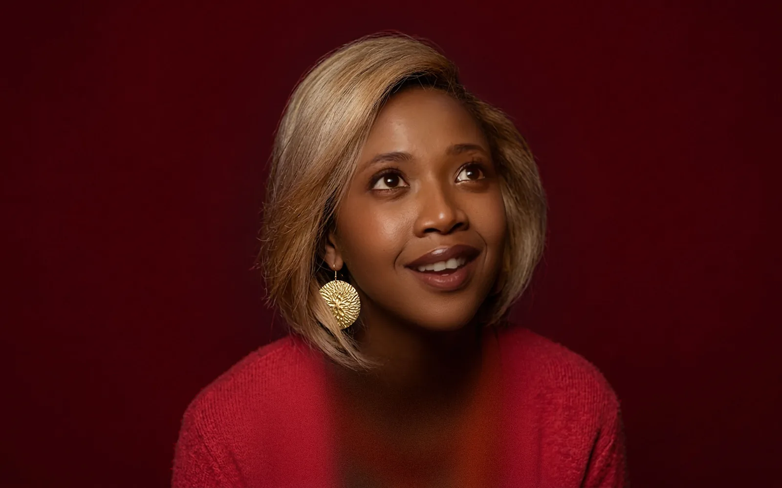 A smiling woman looking up, from the Absa ChatBanking campaign