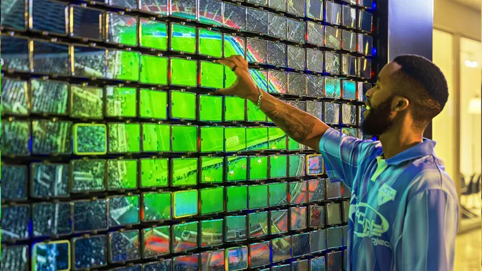 A participant interacting with the phone-powered Social Screen installation